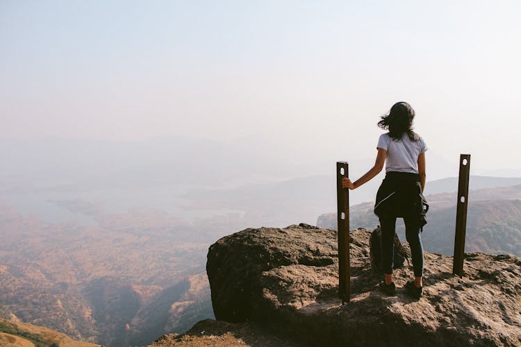 Woman Standing On Mountain Top