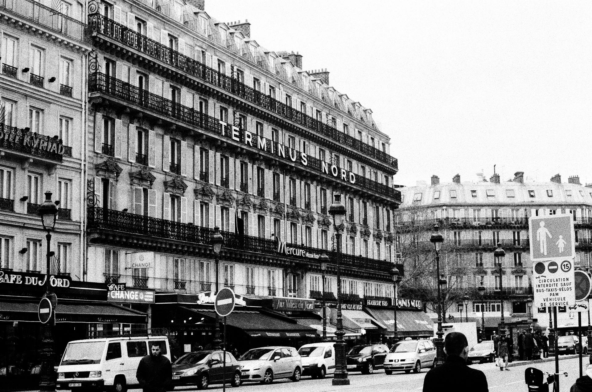 Classic street scene of Paris featuring the iconic Terminus Nord building.