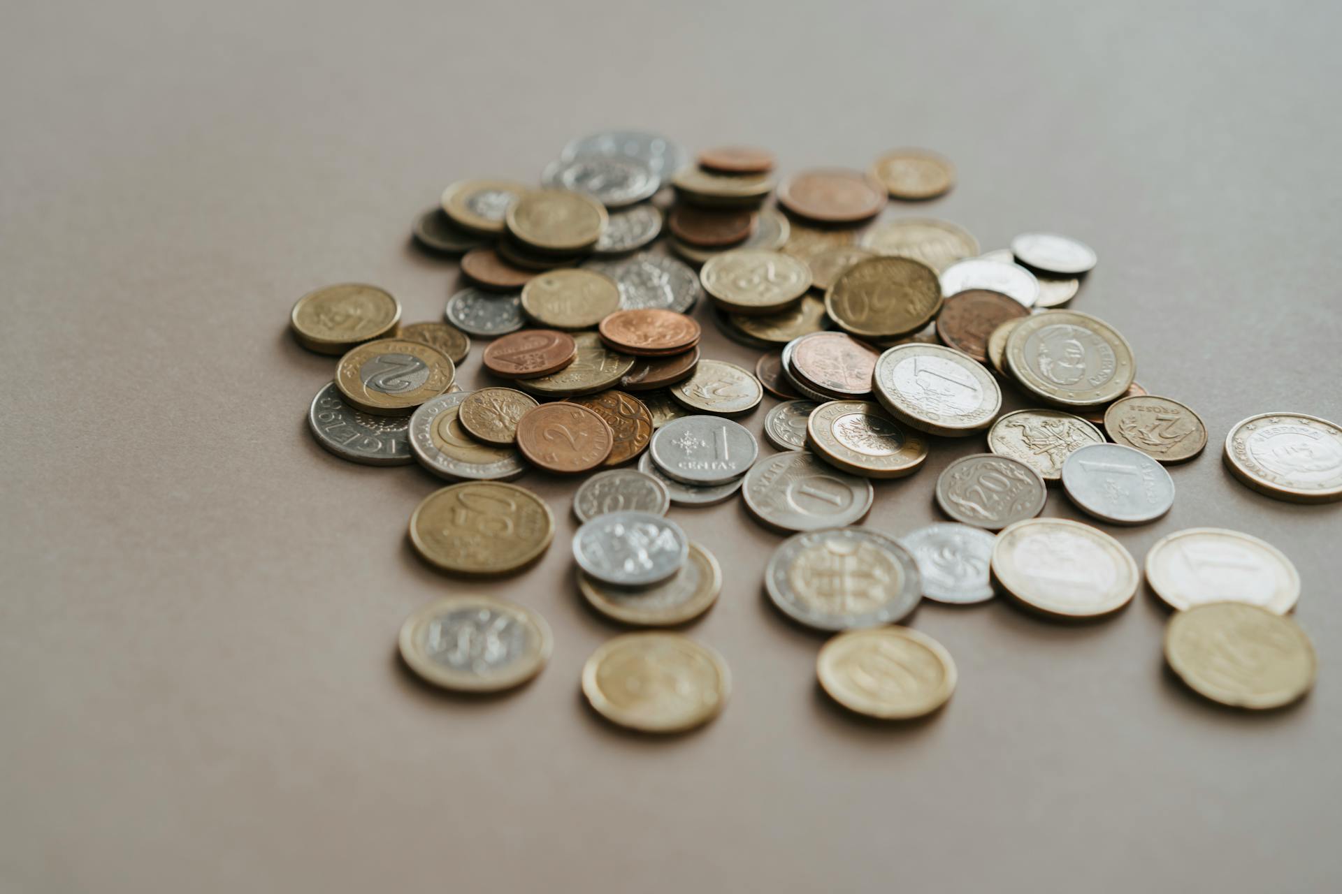 Silver and Gold Round Coins on the Table