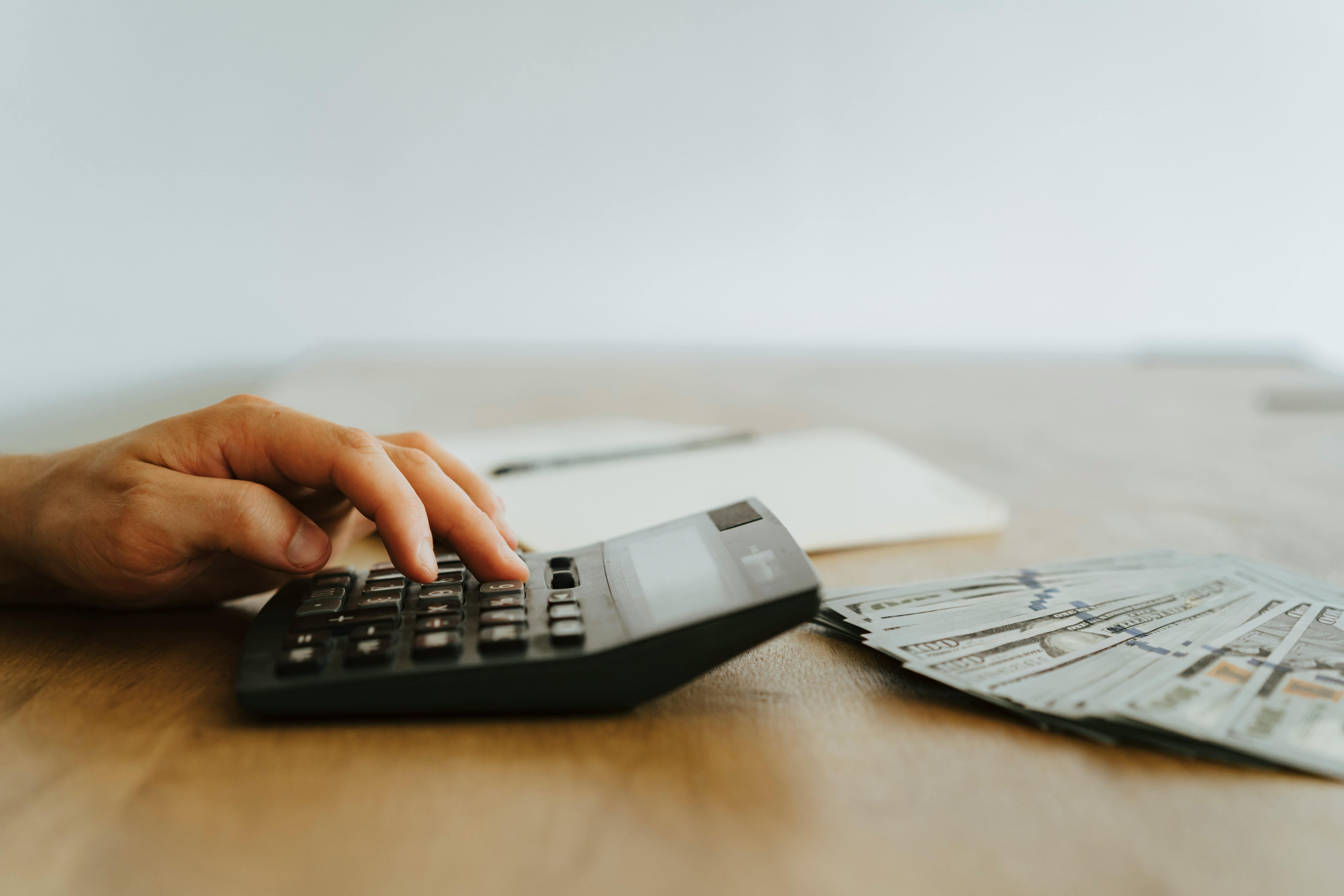 close up photo of person using calculator