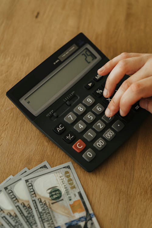 Free Person Using A Black Calculator Stock Photo
