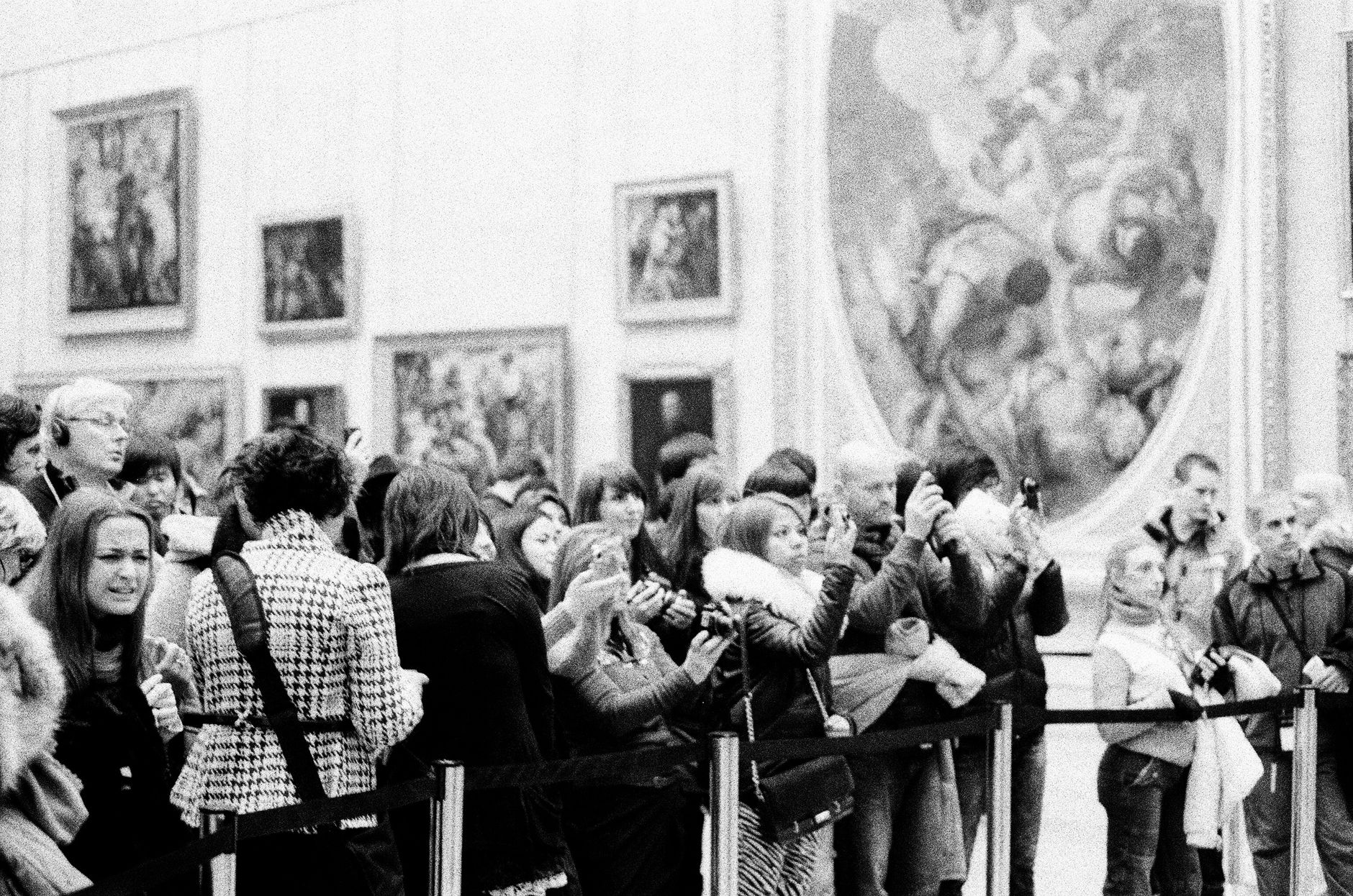 Visitors photographing an artwork in a museum