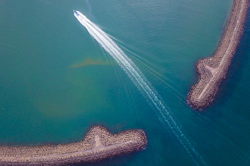 Boat sailing through blue sea water