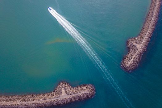 Boat sailing through blue sea water