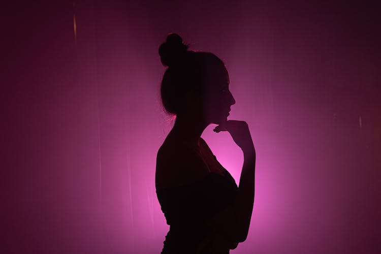 Woman Silhouette On Pink Background