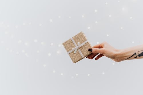 Free A Person Holding Brown Gift Box Stock Photo