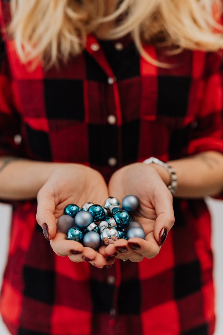 Woman Holding Little Blue Baubles