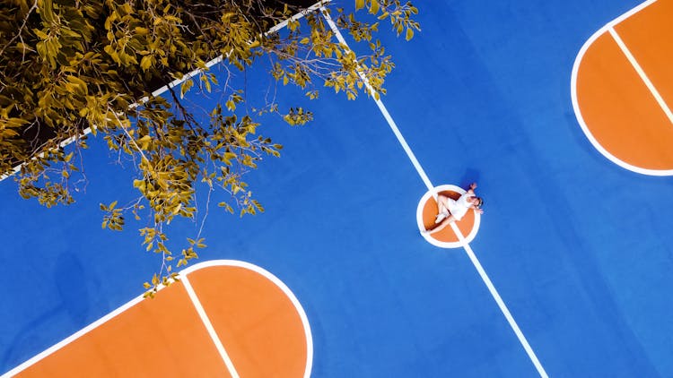 Young Woman Resting On Sports Court