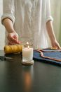 Hand Lighting a Candle Using a Matchstick