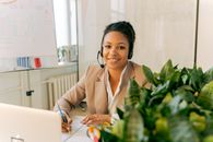 Woman in White Blazer Sitting by the Table