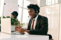 Man in Black Suit Jacket Sitting at the Table