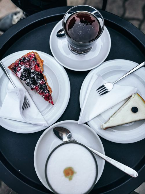 Free Flat lay of assorted pastries, coffee, and cappuccino on a cafe table setting. Stock Photo