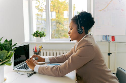 Woman in Brown Blazer Using Laptop 