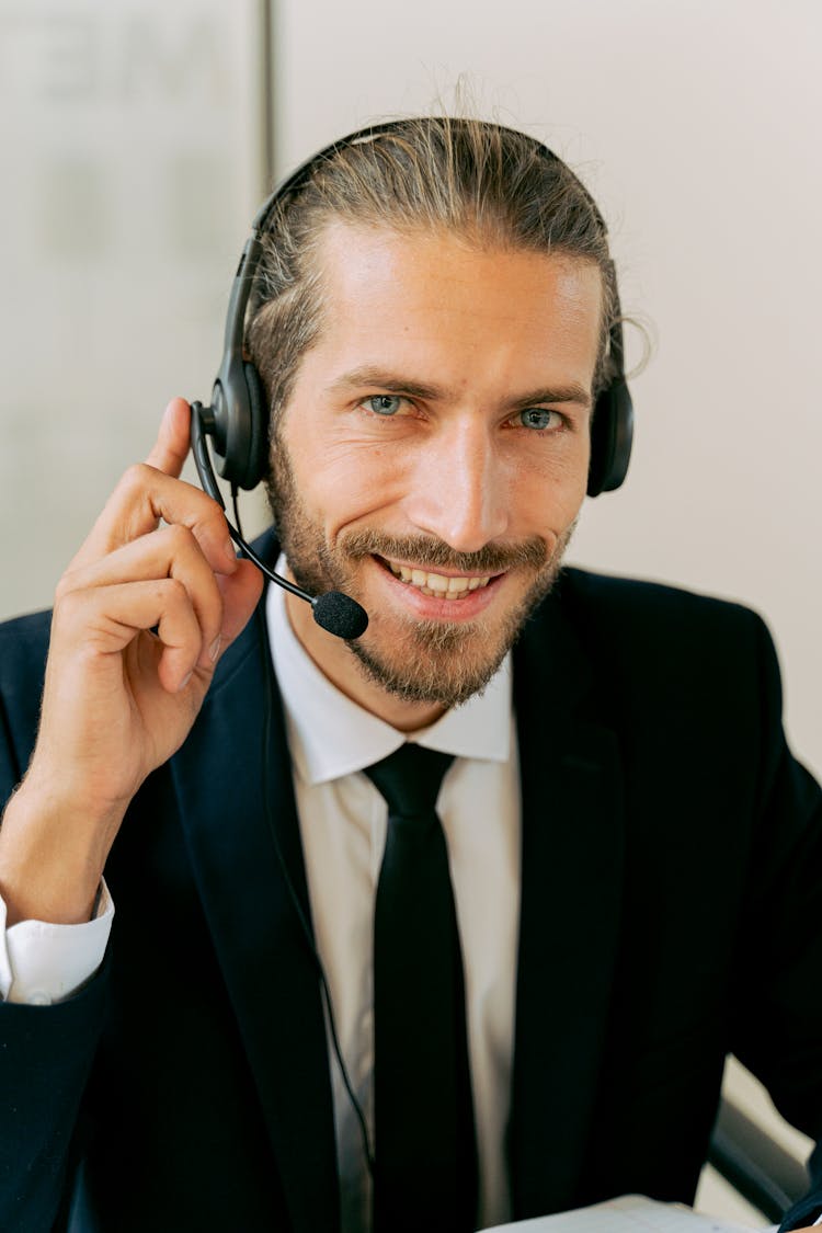 Man In Black Suit Wearing A Black Headset