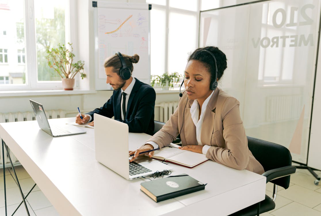 Free Man and Woman Working Wearing Headsets  Stock Photo