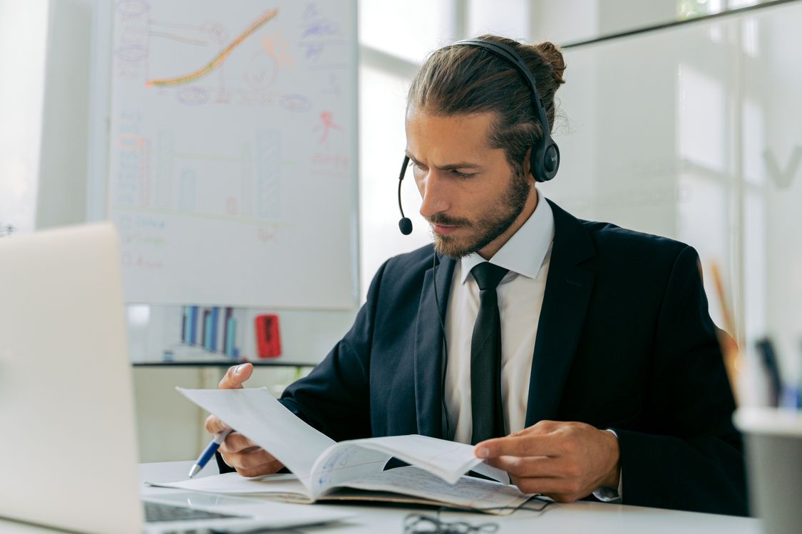 Man in Black Suit Jacket Checking on Records in a Notebook · Free Stock ...