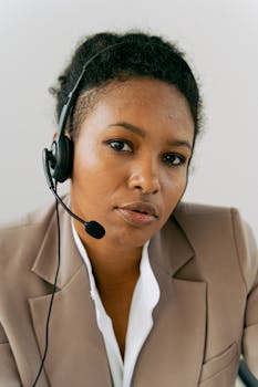 Close-up of a professional woman providing customer support with a headset.