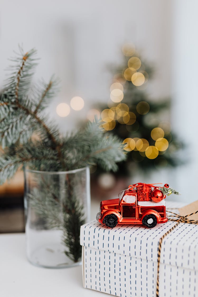 A Toy Car On Top Of A Christmas Present