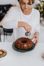 Woman Pouring Hot Chocolate on Bundt Cake