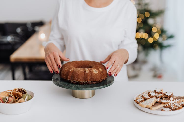 Woman Serving Homemade Cake On Christmas Day 