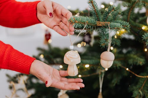 Person Holding a White Mushroom Shaped Christmas Ornament