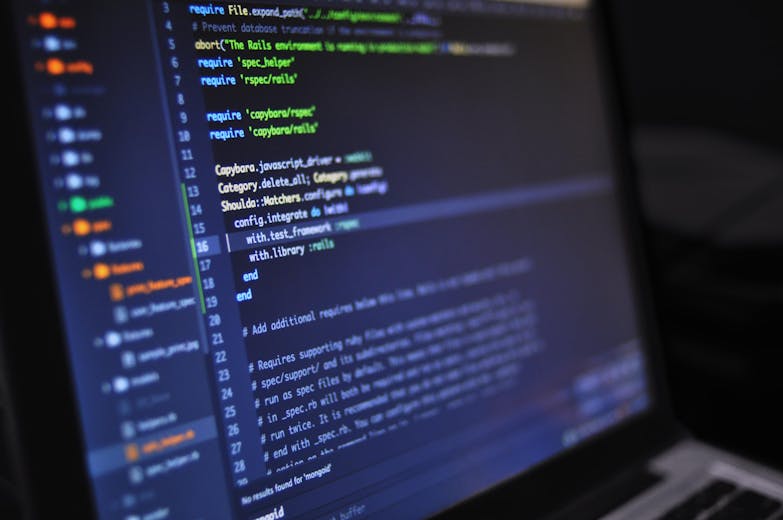 Developer carefully writing lines of code on a computer monitor