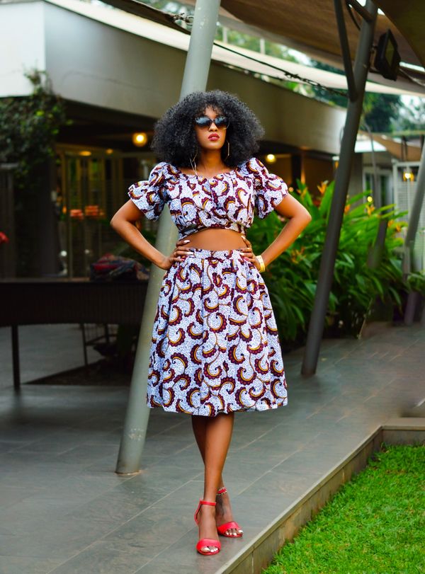 Woman wearing a matching two piece crop top and skirt set