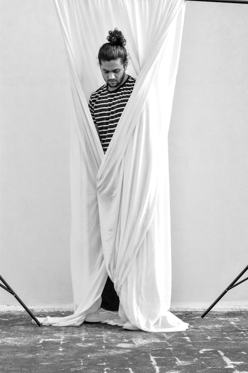 Free 
Grayscale Photography of a Man Covering Himself with White Textile Stock Photo