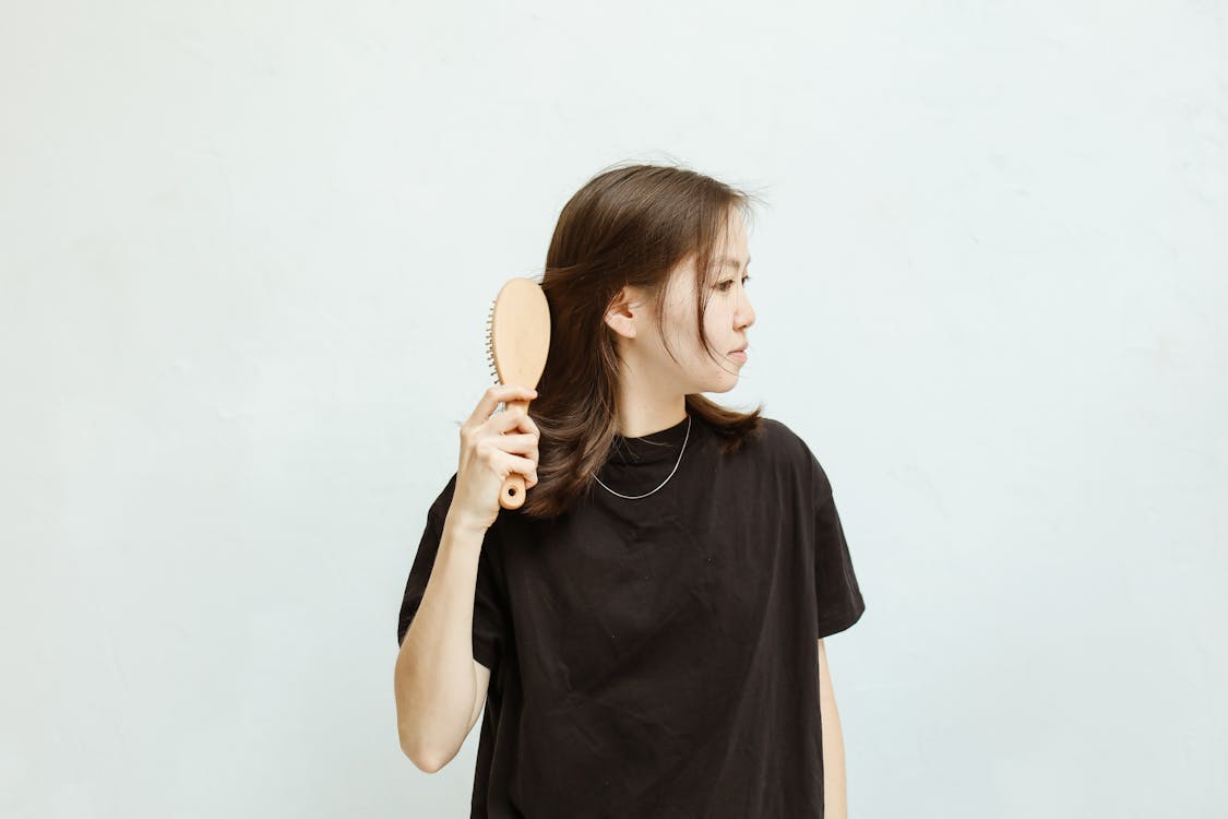 Free A Woman Combing Her Hair Stock Photo