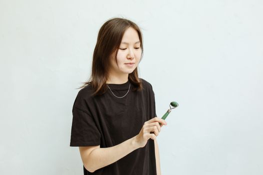 A Woman Holding a Facial Roller