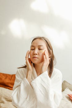 Adult woman with under eye masks, relaxing in natural light, focusing on skincare.