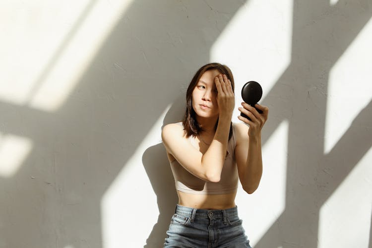 Woman In Beige Crop Top Putting On Makeup 