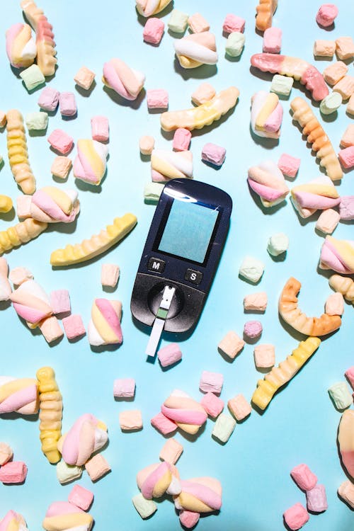 Free A Glucometer Surrounded by Candies Stock Photo