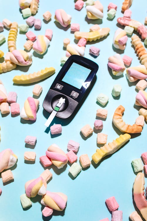 Free A Glucometer Surrounded by Colorful Candies Stock Photo