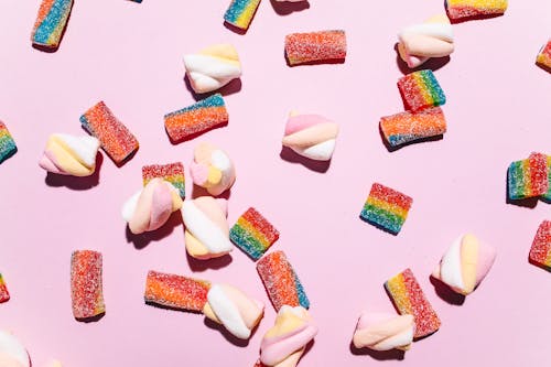 Close-Up Shot of Sweet Candies on Pink Background