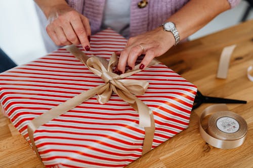 Close-Up Shot of a Person Opening a Christmas Present