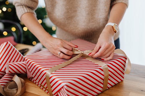 Close-Up Shot of a Person Opening a Christmas Present