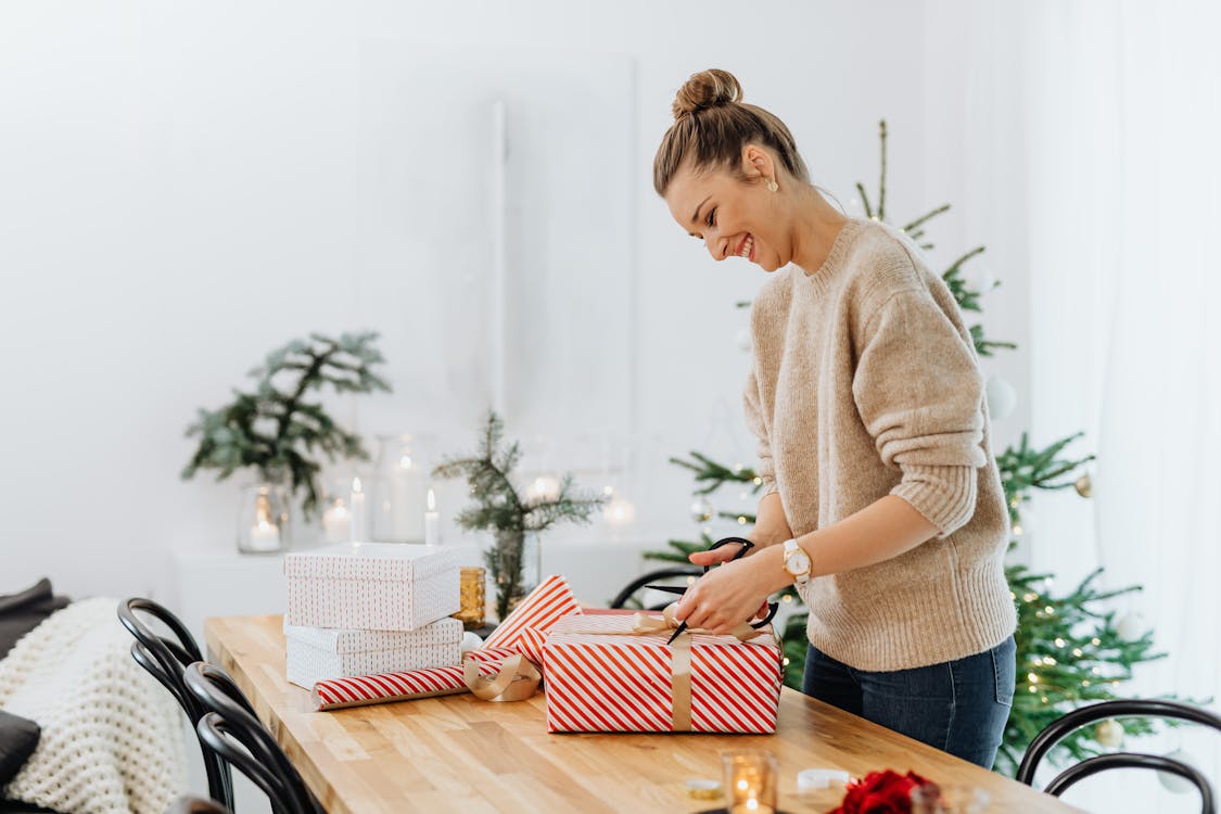 Free A Woman Opening a Christmas Present Stock Photo
