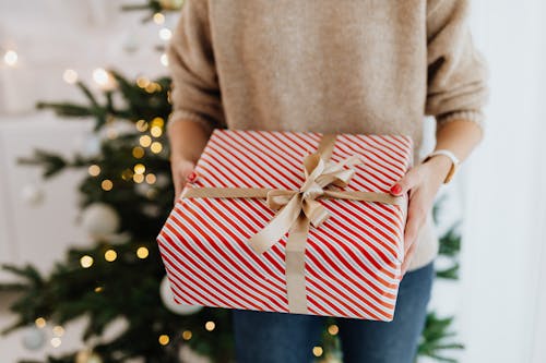 Free Close-Up Shot of a Person Holding a Christmas Present Stock Photo