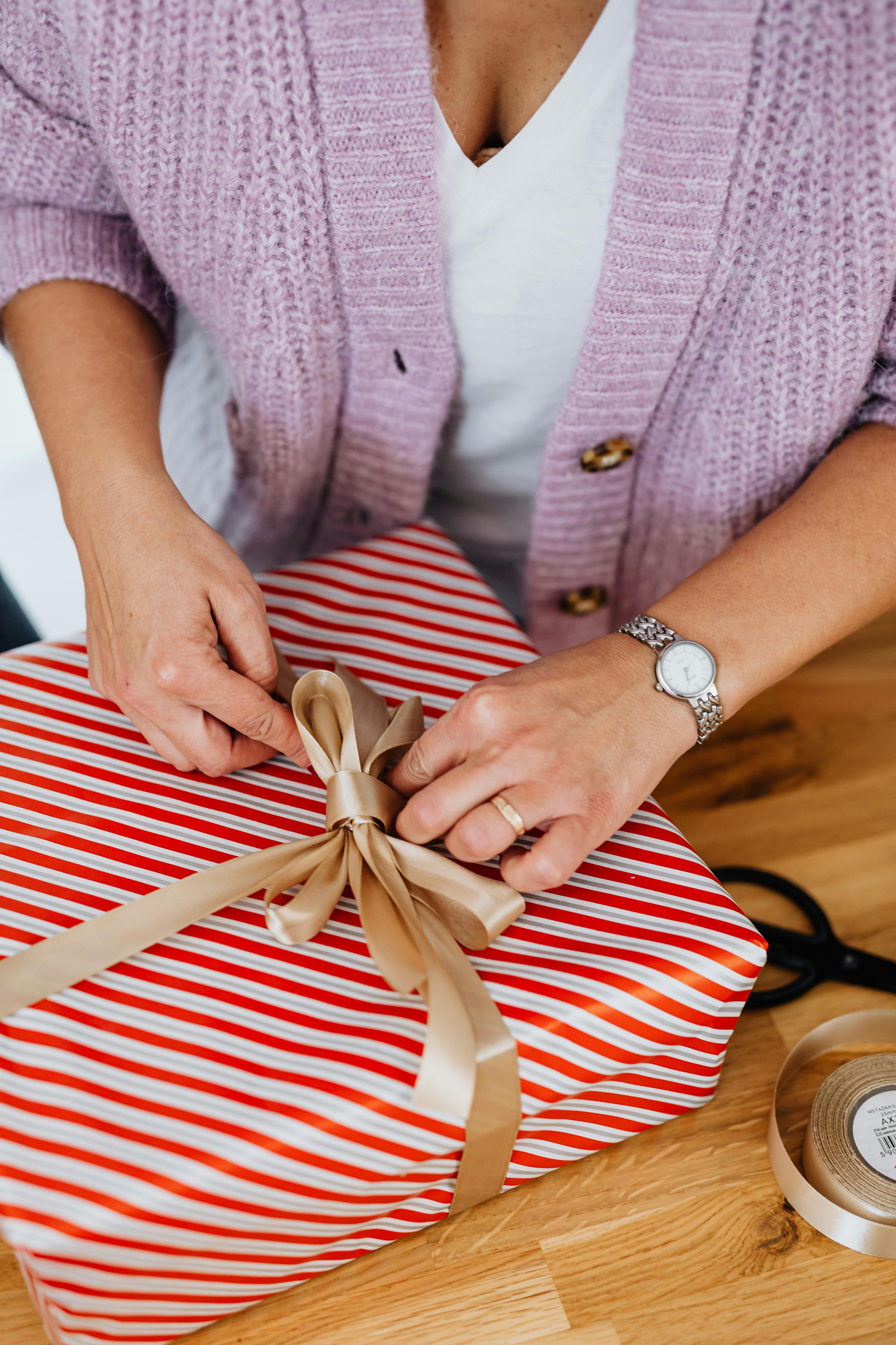 close up shot of a person opening a christmas present