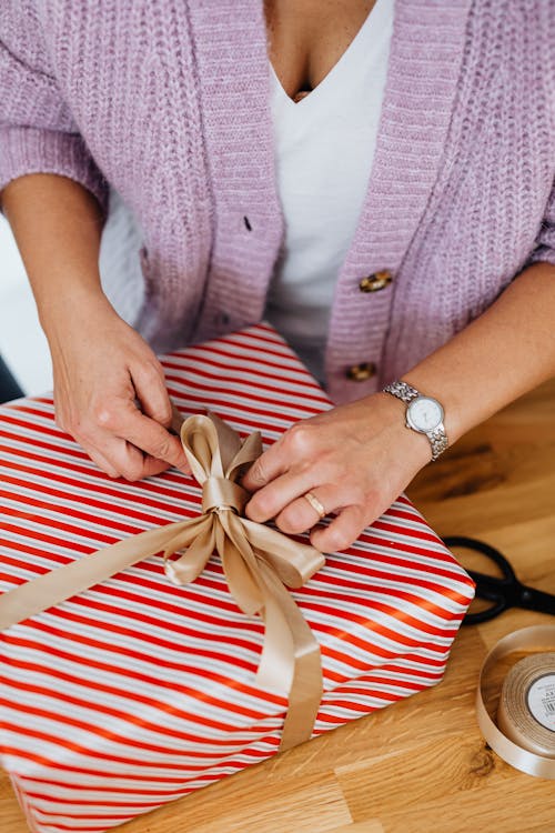 Close-Up Shot of a Person Opening a Christmas Present