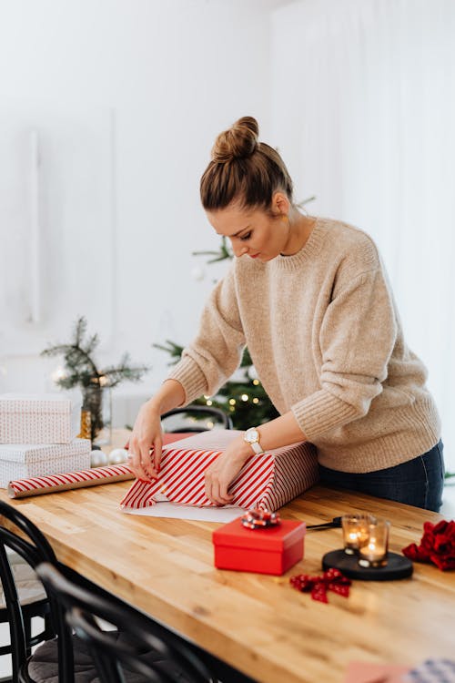 A Woman Wrapping a Christmas Present