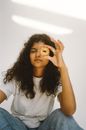 Girl in White Crew Neck T-shirt Holding Her Hair