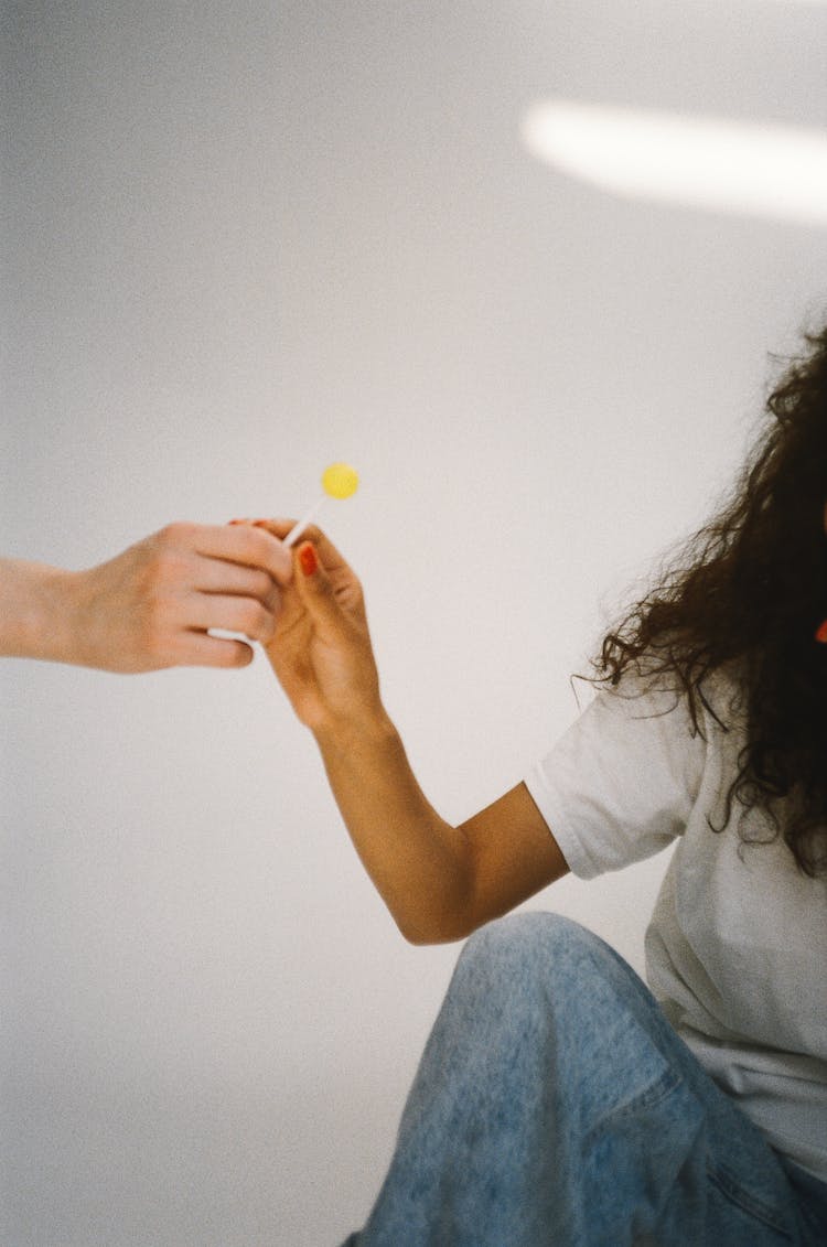 Person Holding A Lollipop