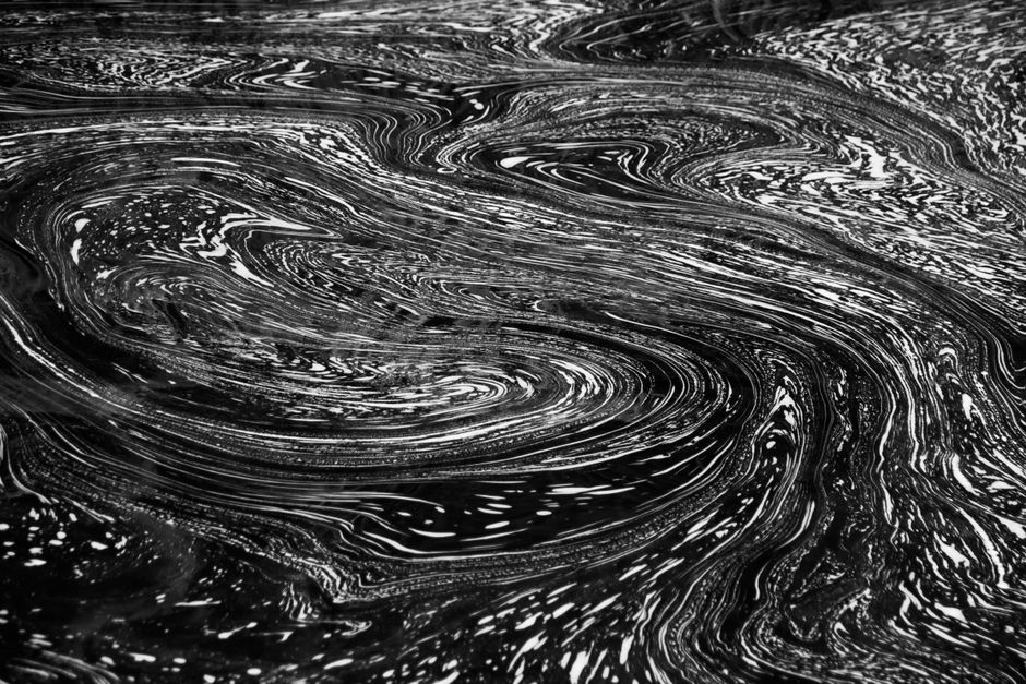 Mesmerizing black and white swirl texture ideal for backgrounds or abstract art themes.