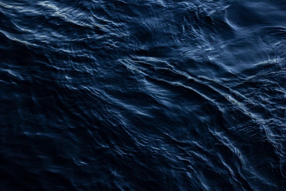 A mesmerizing view of the ocean's surface with dark ripples creating a dramatic effect.