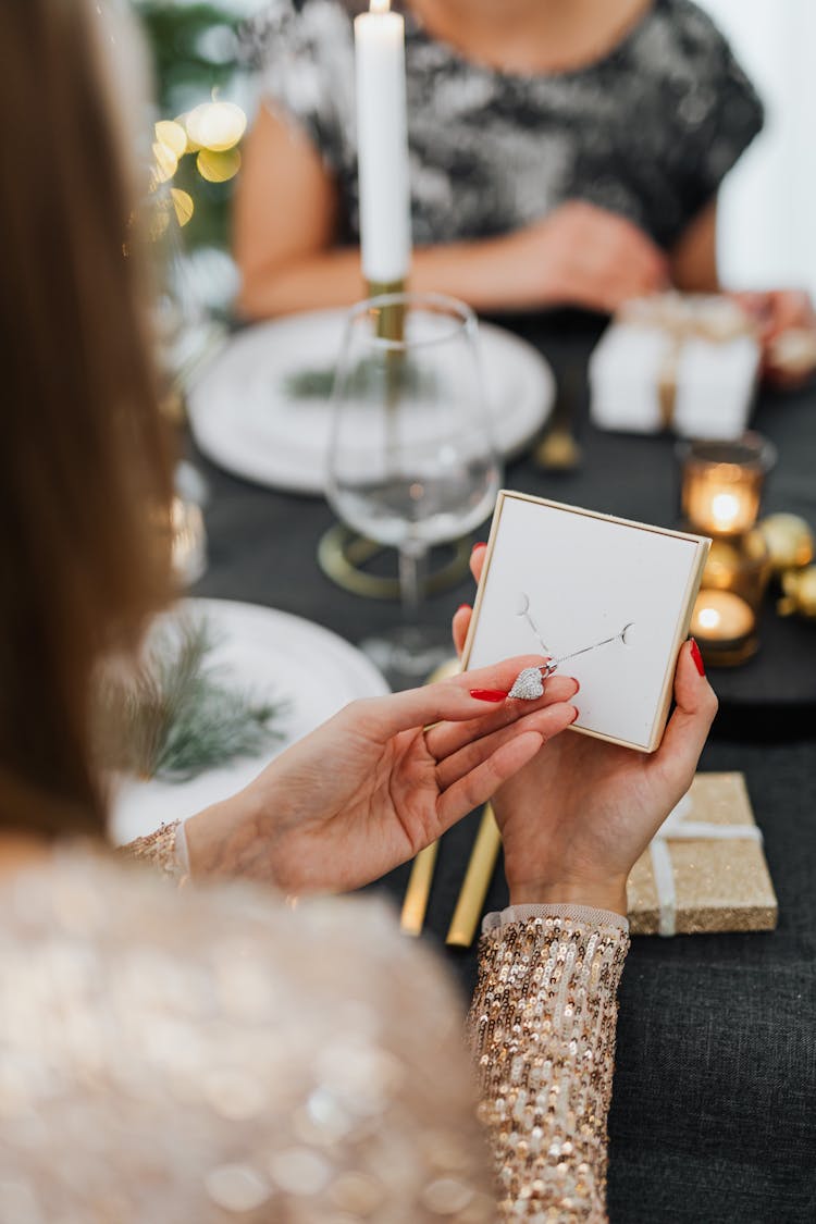 Woman Holding Earring In Box