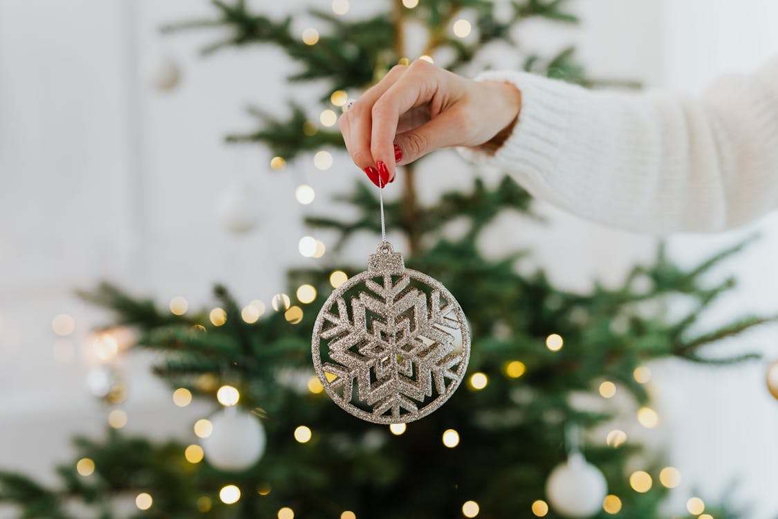 Woman Hand Holding Christmas Tree Decoration
