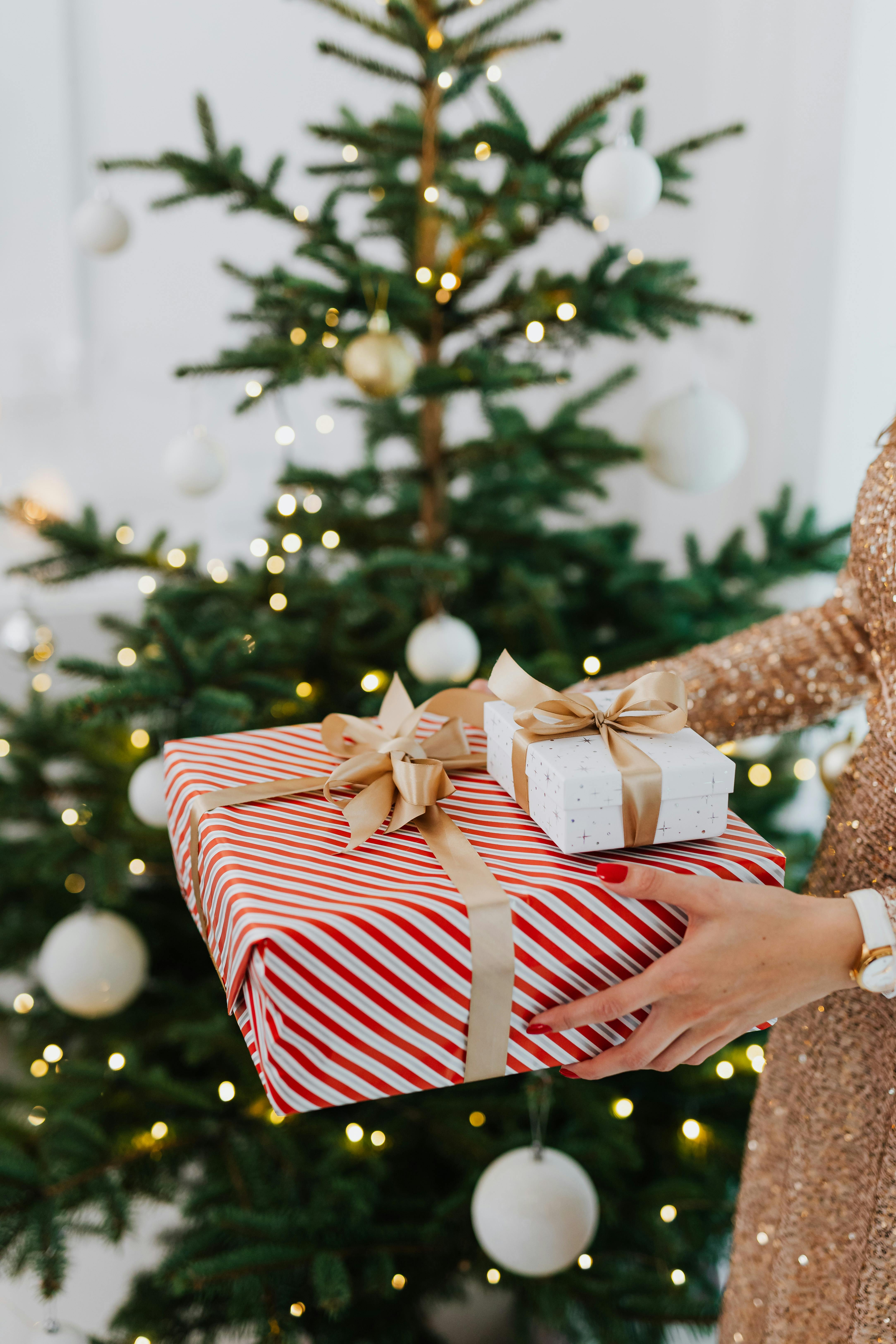 woman holding wrapped christmas presents