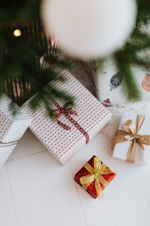 matching-gift-wrapping Coordinated wrapped Christmas presents with ribbons under the tree